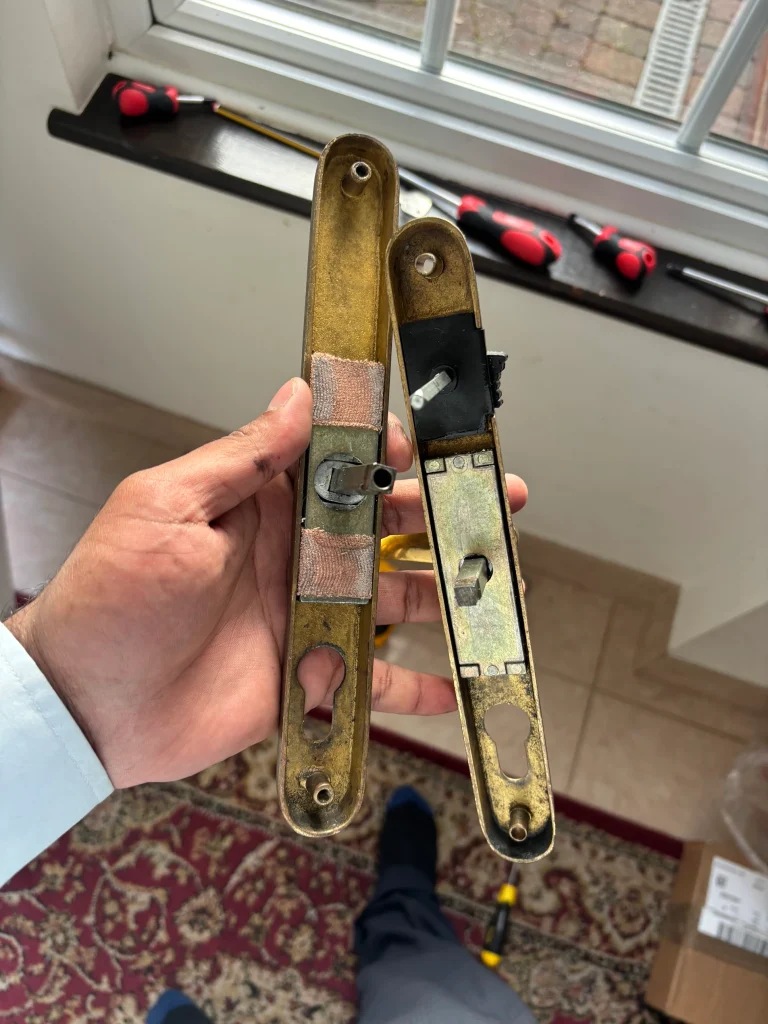 KwikFix Locksmiths inspecting door-lock components during a repair